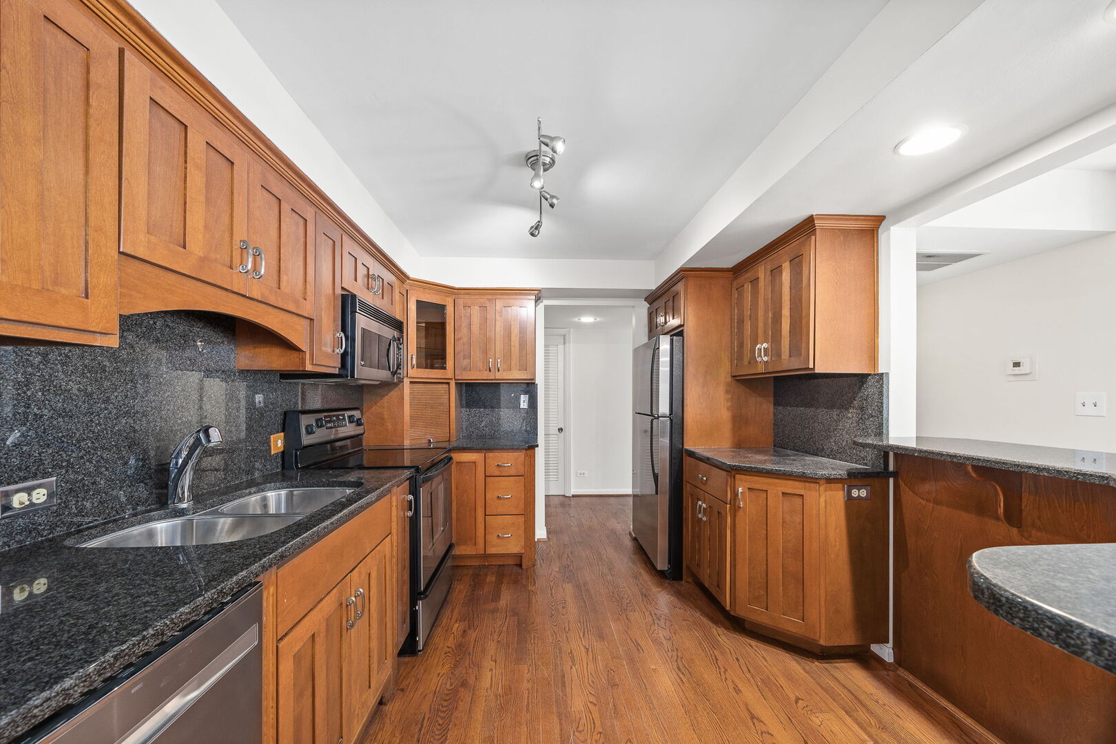 124 Carriage Way Drive, Unit B109 Burr Ridge, IL 60527 - Photo 8 of 31 a kitchen with stainless steel appliances granite countertop a sink stove and cabinets