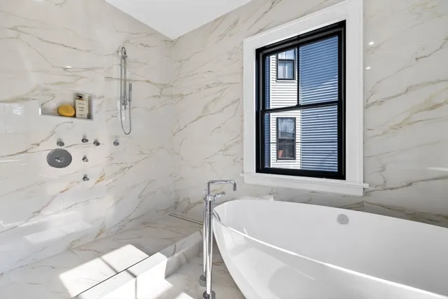 a bathroom with a bathtub and shower
