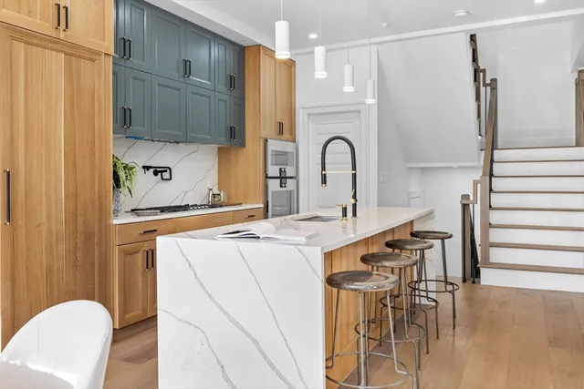a kitchen with a white cabinets appliances and furniture