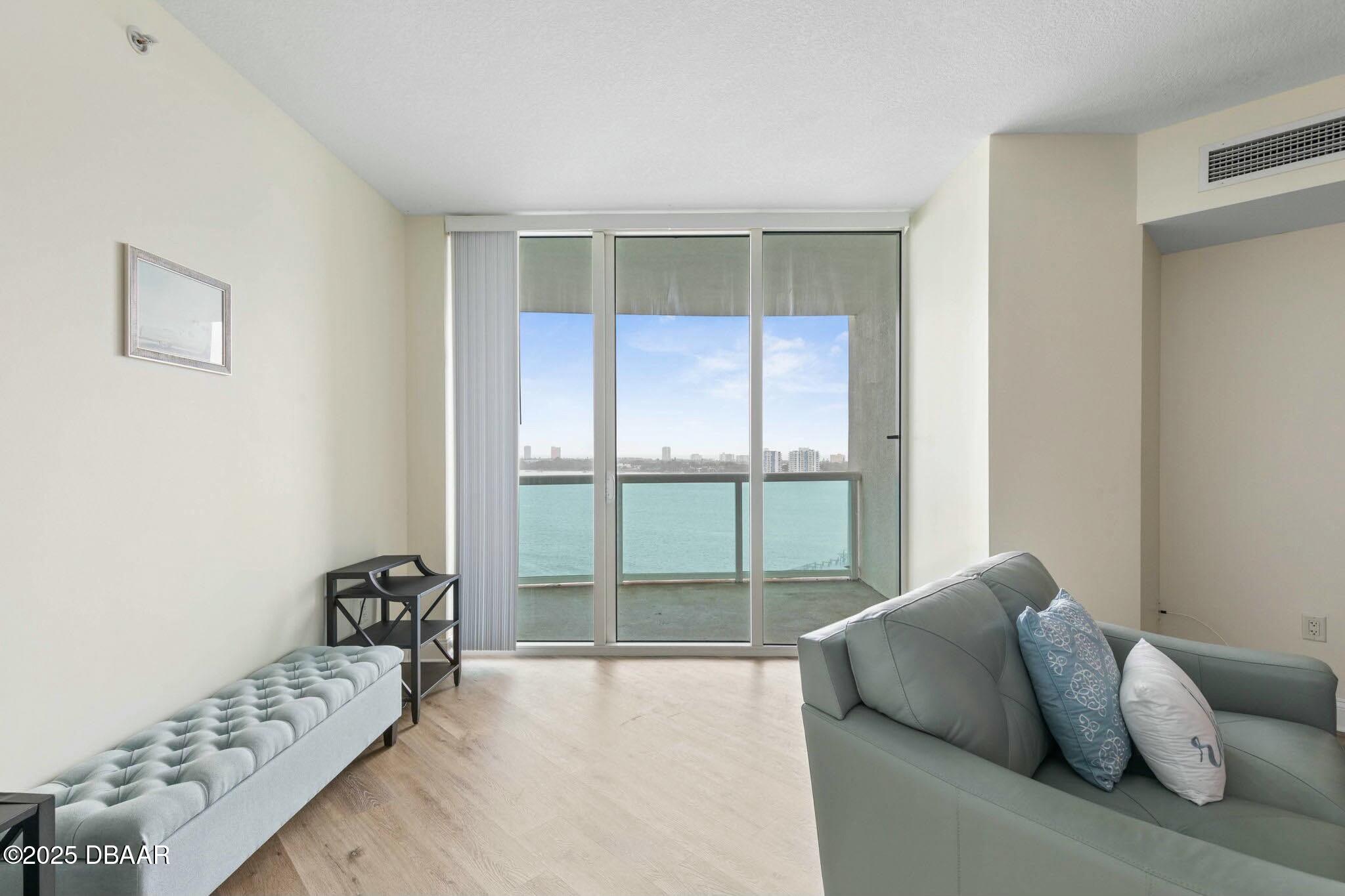 231 Riverside Drive, Unit 1104 Holly Hill, FL 32117 - Photo 12 of 77 a bed room with a bed and a couch