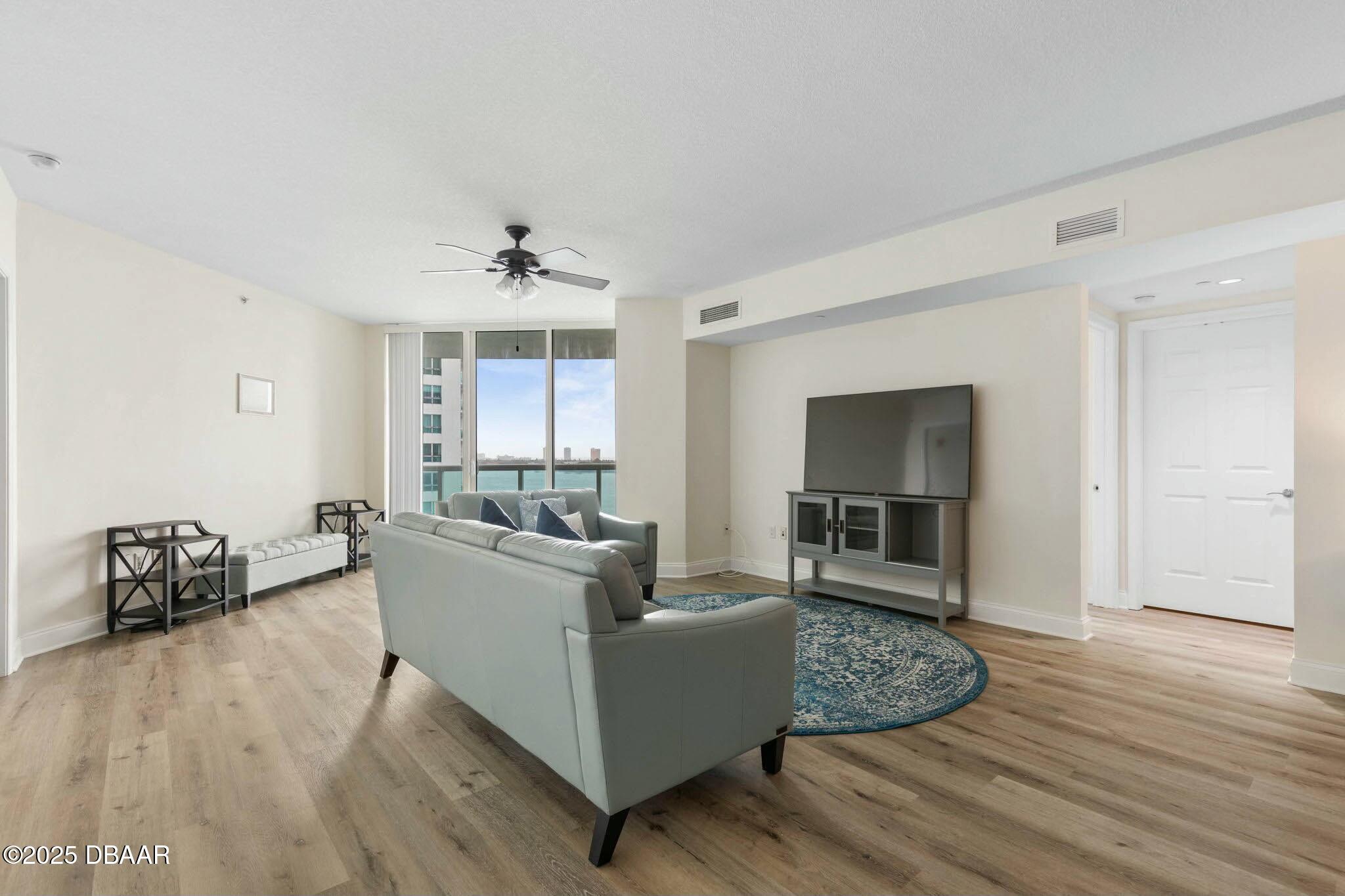 231 Riverside Drive, Unit 1104 Holly Hill, FL 32117 - Photo 13 of 77 a living room with furniture and a wooden floor