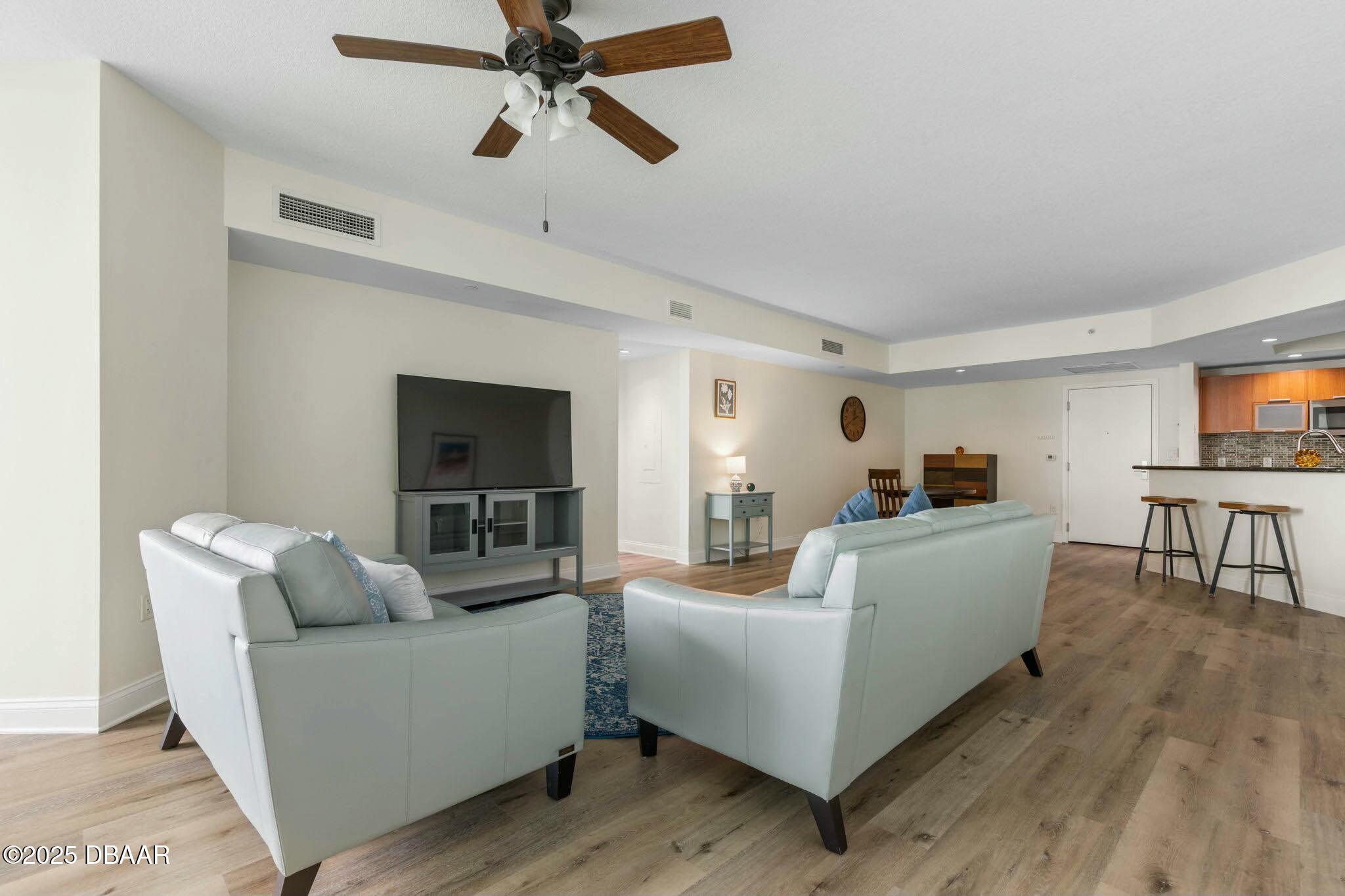 231 Riverside Drive, Unit 1104 Holly Hill, FL 32117 - Photo 14 of 77 a living room with furniture and a flat screen tv