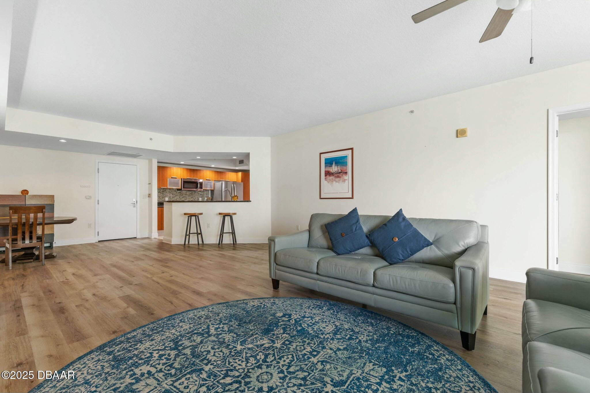 231 Riverside Drive, Unit 1104 Holly Hill, FL 32117 - Photo 15 of 77 a living room with furniture and a flat screen tv