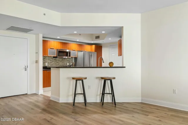 a kitchen with stainless steel appliances wooden cabinets and a stove top oven