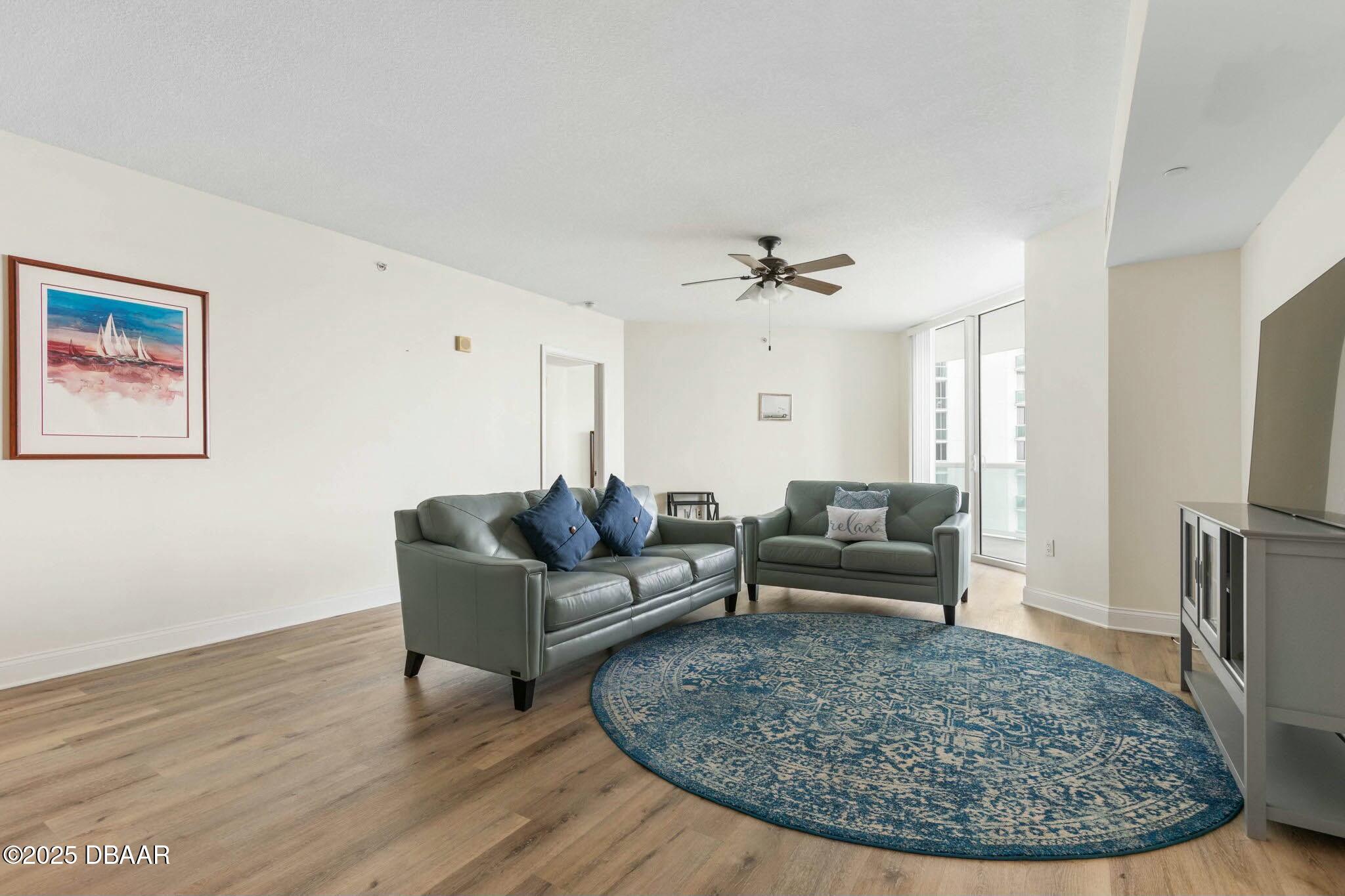 231 Riverside Drive, Unit 1104 Holly Hill, FL 32117 - Photo 25 of 77 a living room with furniture and a wooden floor