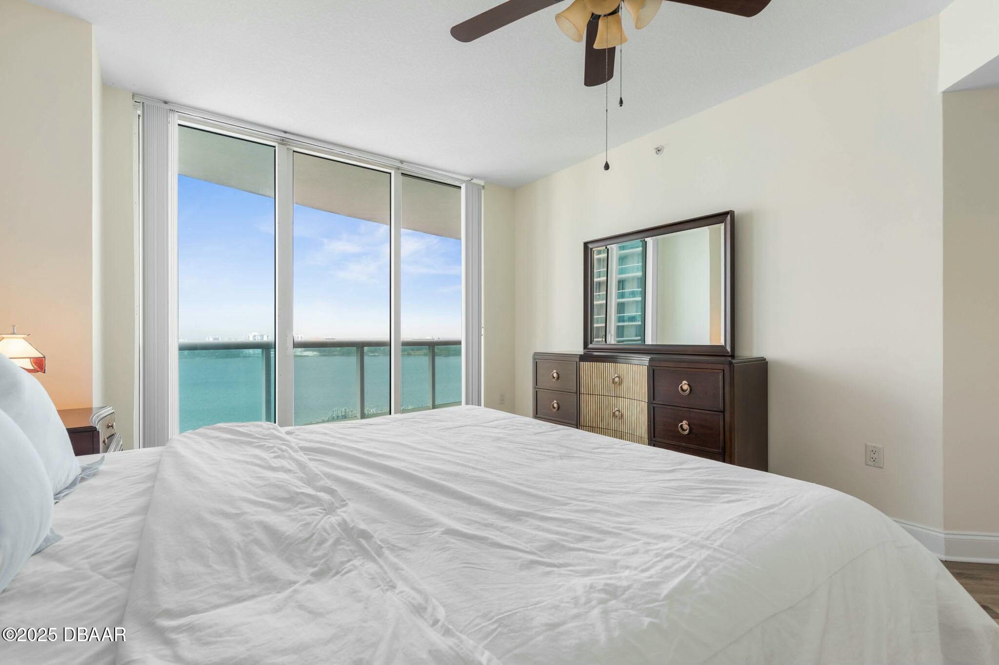 231 Riverside Drive, Unit 1104 Holly Hill, FL 32117 - Photo 27 of 77 a large bedroom with a large bed and a large window