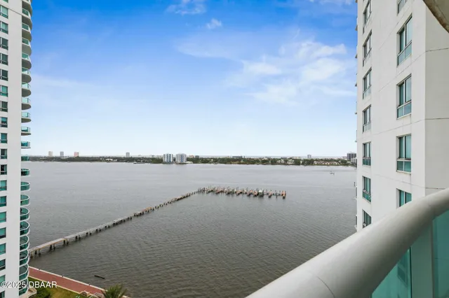 a bedroom with a bed a television and a large window