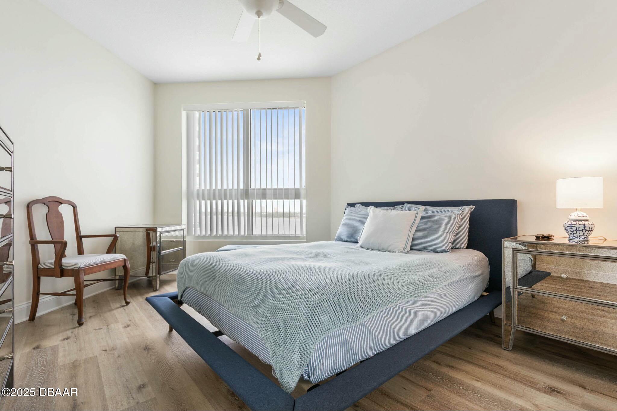 231 Riverside Drive, Unit 1104 Holly Hill, FL 32117 - Photo 38 of 77 a bedroom with a bed and a couch