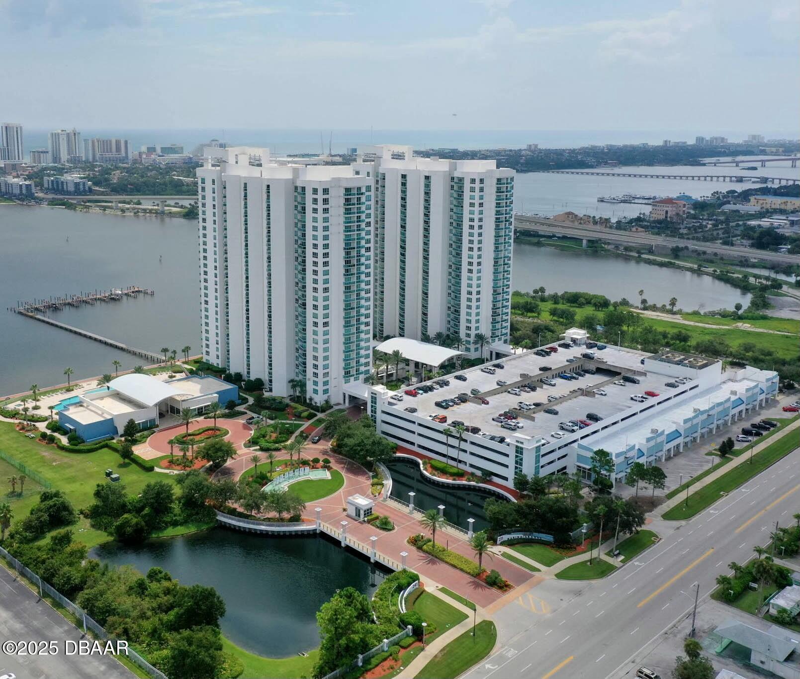 231 Riverside Drive, Unit 1104 Holly Hill, FL 32117 - Photo 4 of 77 a aerial view of a house with a garden and lake view