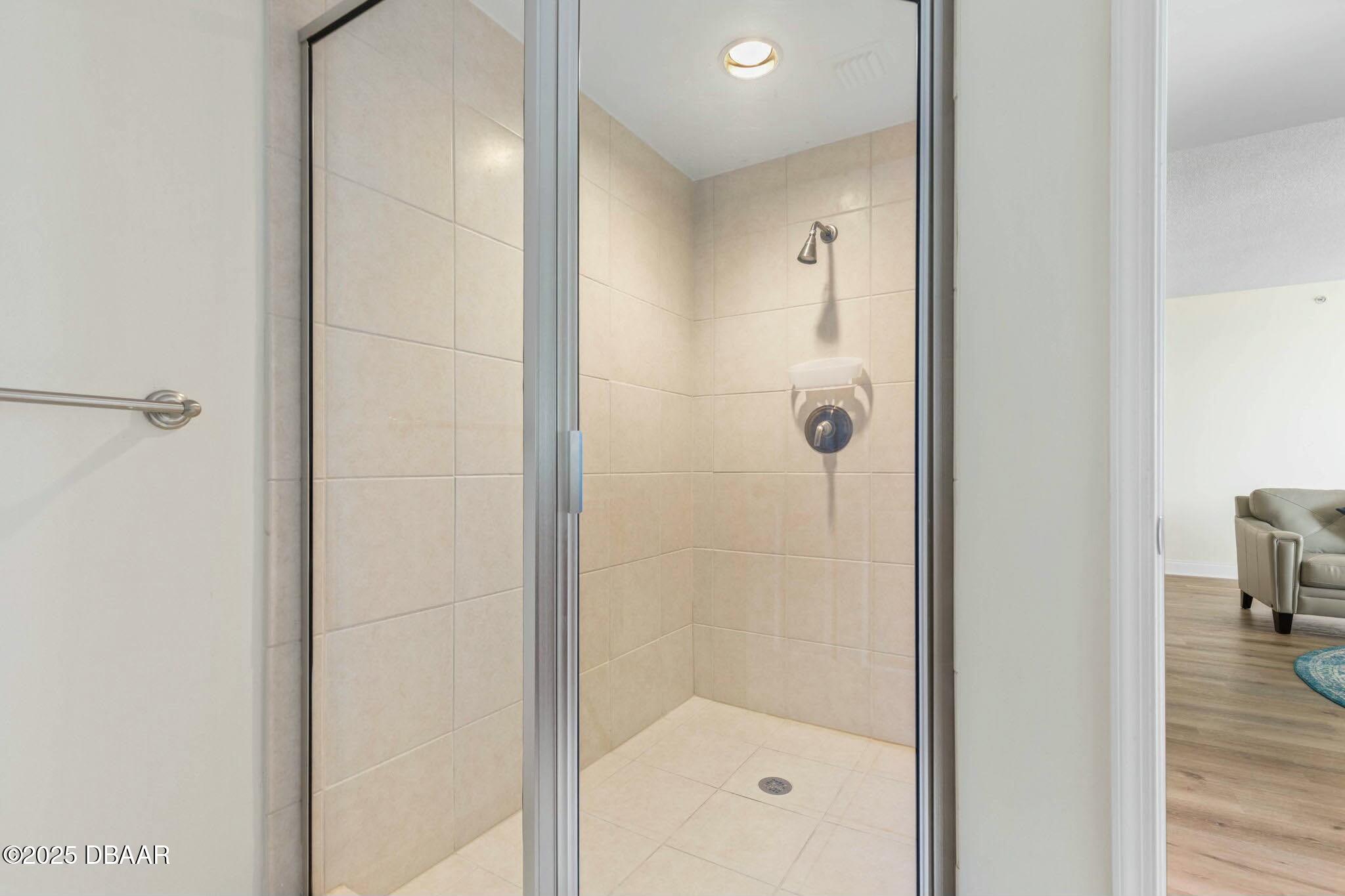 231 Riverside Drive, Unit 1104 Holly Hill, FL 32117 - Photo 42 of 77 a bathroom with a glass shower door