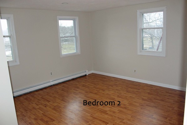 120 Gordon Road Braintree, MA 02184 - Photo 8 of 14 an empty room with wooden floor and windows