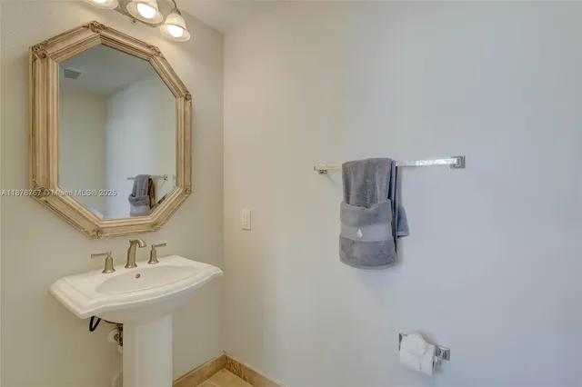 a bathroom with a sink a mirror and vanity
