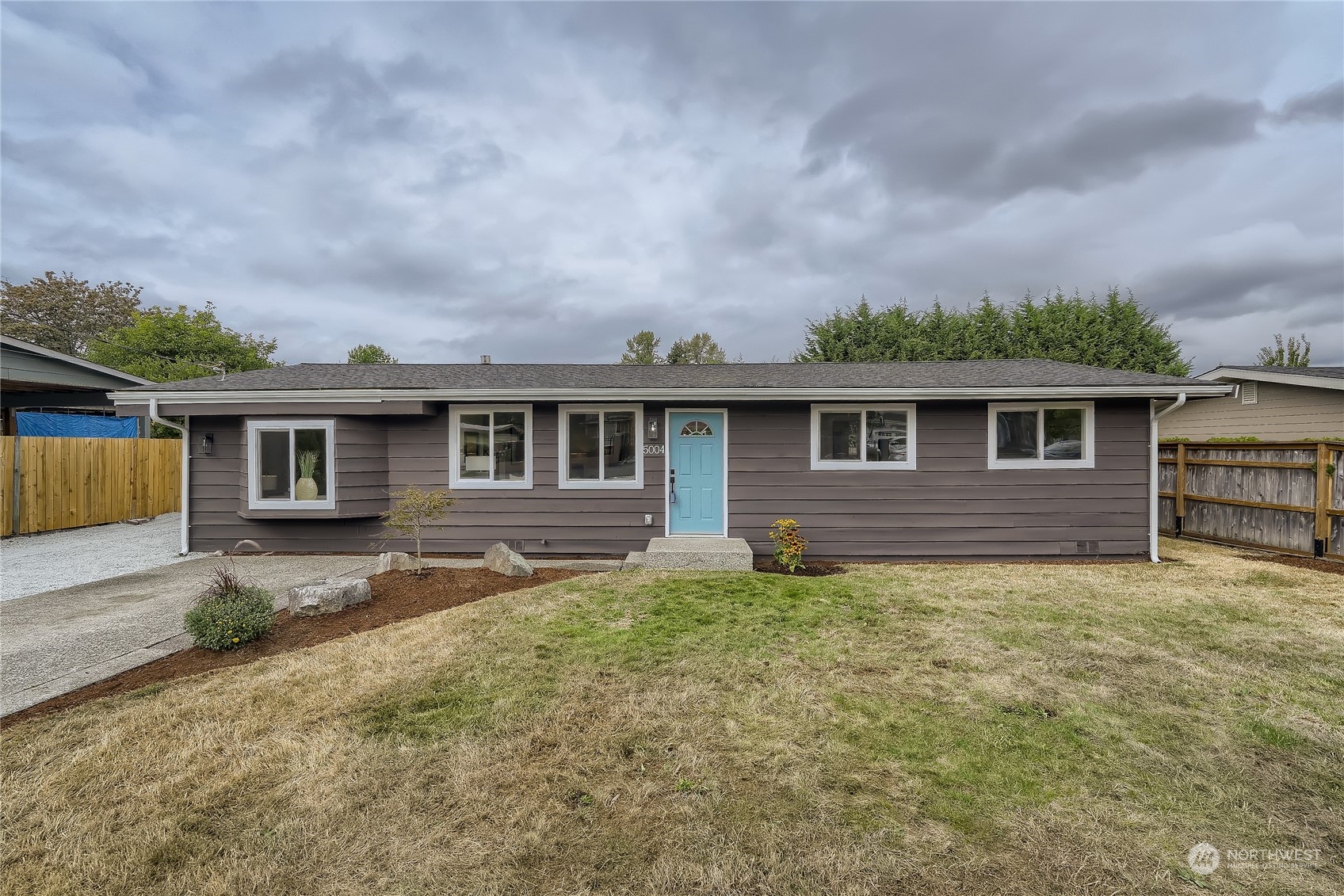 5004 Northeast 7th Place Renton, WA 98059 - Photo 1 of 28 a backyard of a house with yard fire pit barbeque oven and outdoor seating