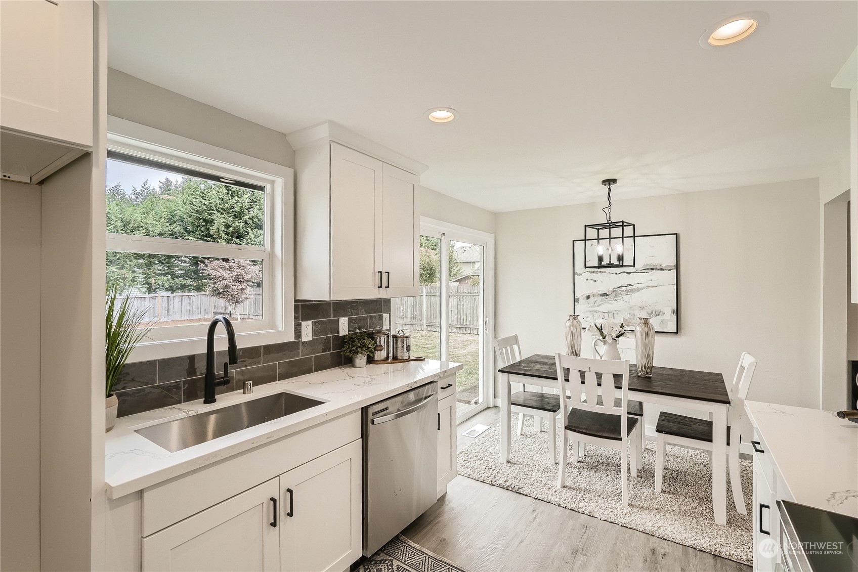 5004 Northeast 7th Place Renton, WA 98059 - Photo 11 of 28 a kitchen with a sink table and chairs