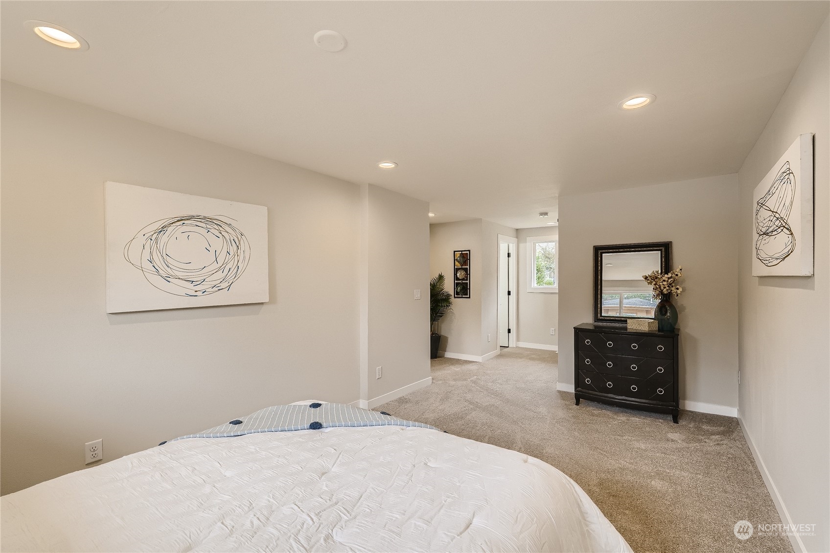 5004 Northeast 7th Place Renton, WA 98059 - Photo 18 of 28 a bedroom with a bed and a chandelier
