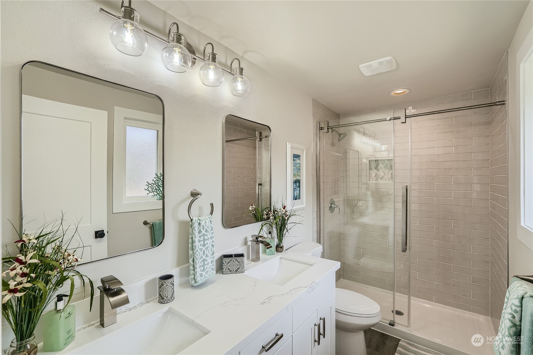 5004 Northeast 7th Place Renton, WA 98059 - Photo 19 of 28 a bathroom with a double vanity sink toilet and shower