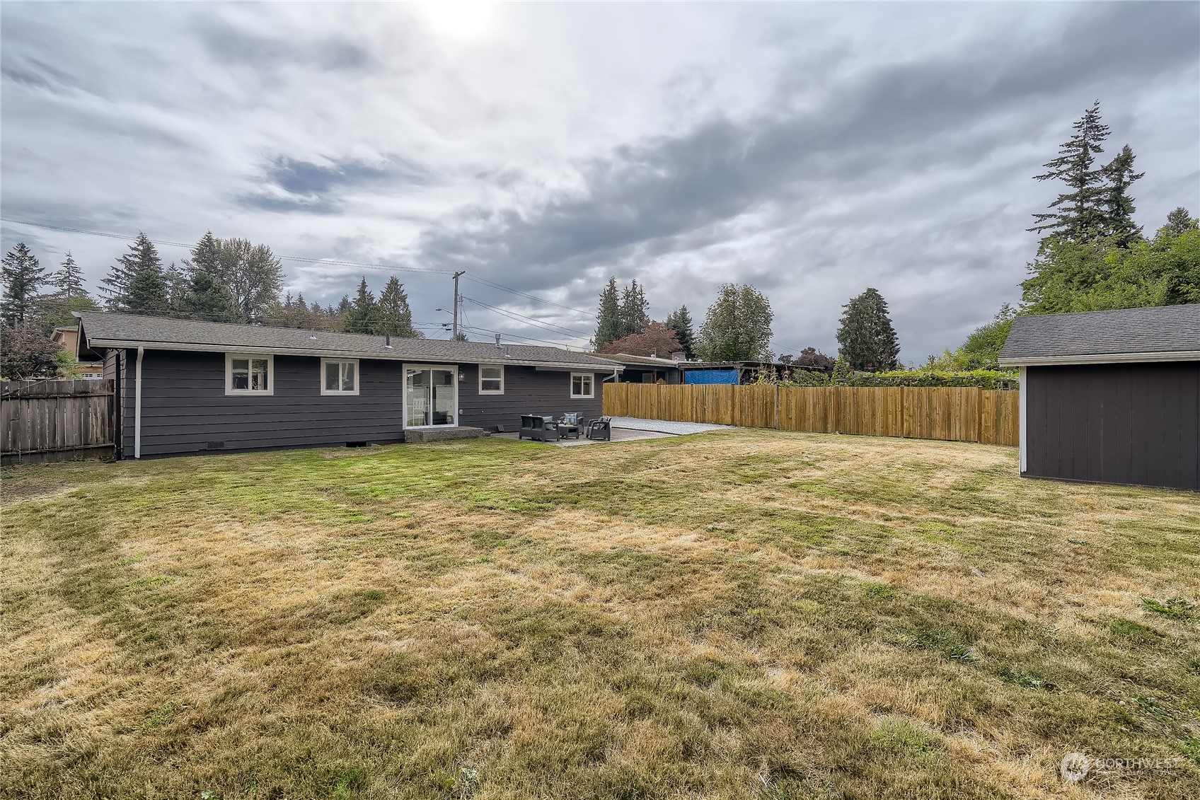 5004 Northeast 7th Place Renton, WA 98059 - Photo 26 of 28 a view of a house with backyard and wooden fence