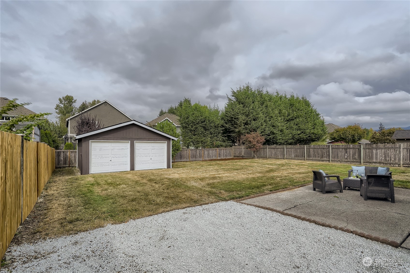 5004 Northeast 7th Place Renton, WA 98059 - Photo 27 of 28 a view of a backyard with potted plants and wooden fence