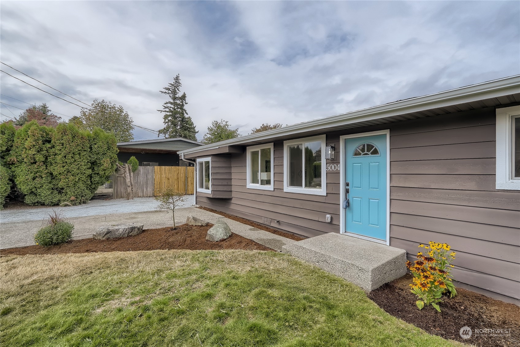 5004 Northeast 7th Place Renton, WA 98059 - Photo 4 of 28 a front view of a house with garden