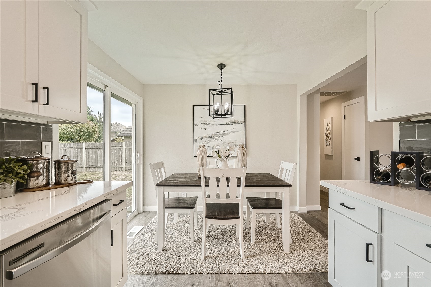5004 Northeast 7th Place Renton, WA 98059 - Photo 9 of 28 a view of a dining room with furniture and large windows