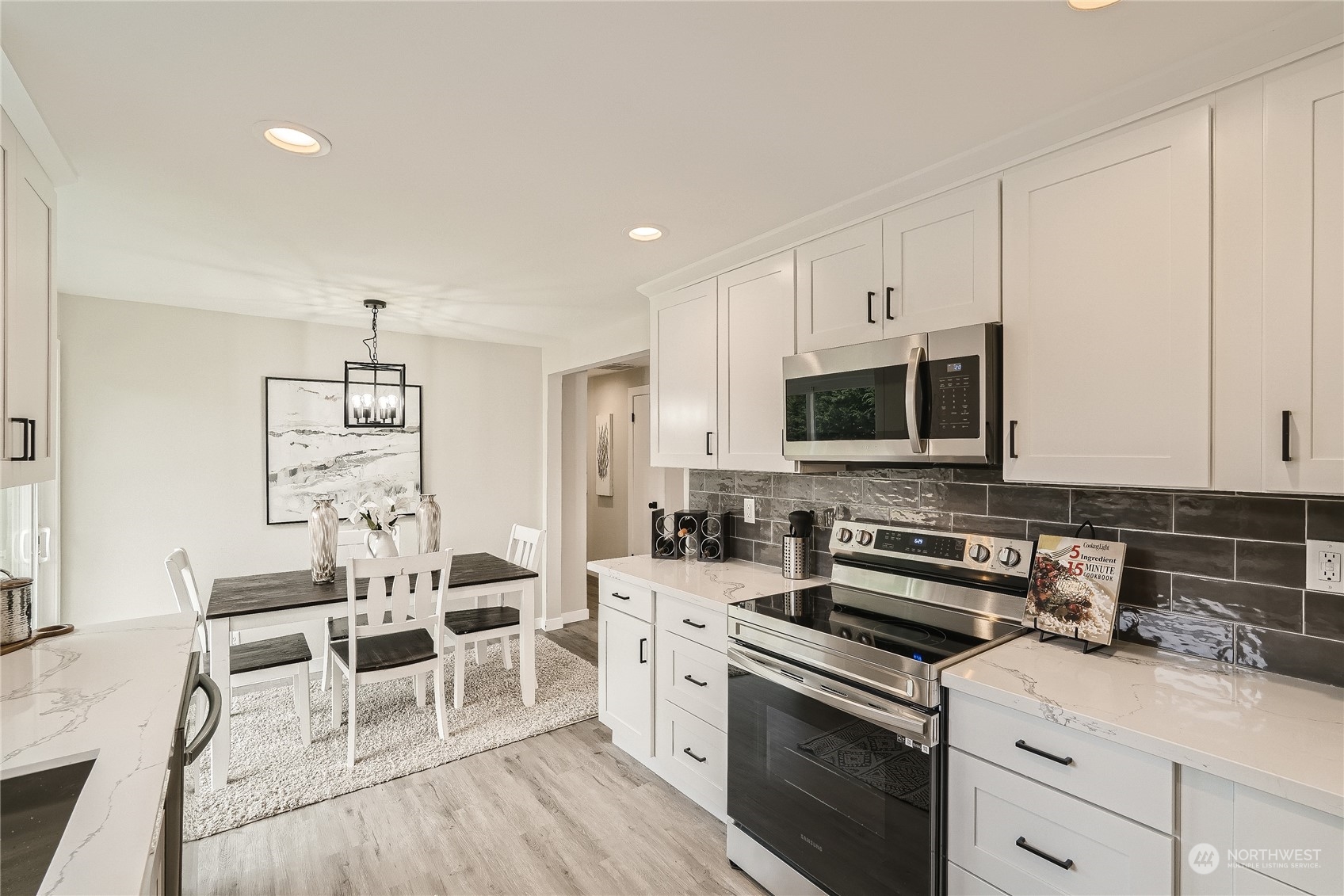 5004 Northeast 7th Place Renton, WA 98059 - Photo 10 of 28 a kitchen with stainless steel appliances a stove a sink cabinets and a microwave