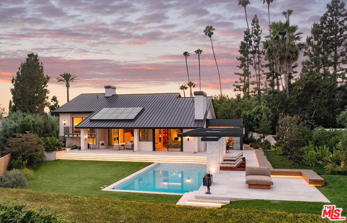 984 North Alpine Drive Beverly Hills, CA 90210 - Photo 1 of 25 a front view of a house with swimming pool having outdoor seating