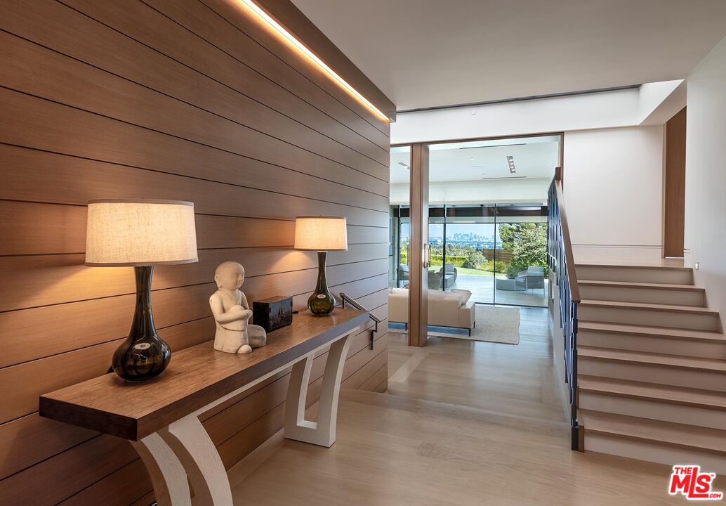 984 North Alpine Drive Beverly Hills, CA 90210 - Photo 13 of 25 a living room with furniture and a lamp