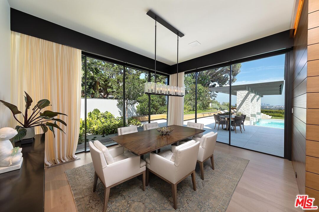 984 North Alpine Drive Beverly Hills, CA 90210 - Photo 15 of 25 a living room with furniture and a large window