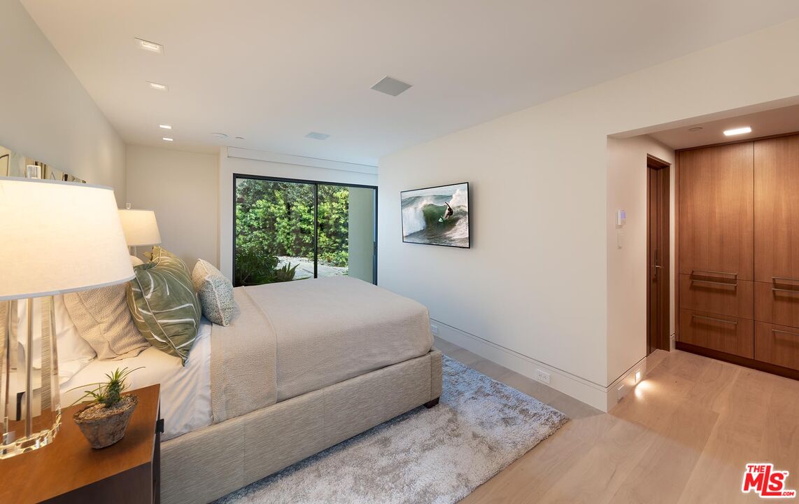 984 North Alpine Drive Beverly Hills, CA 90210 - Photo 22 of 25 a living room with a bed furniture and a window