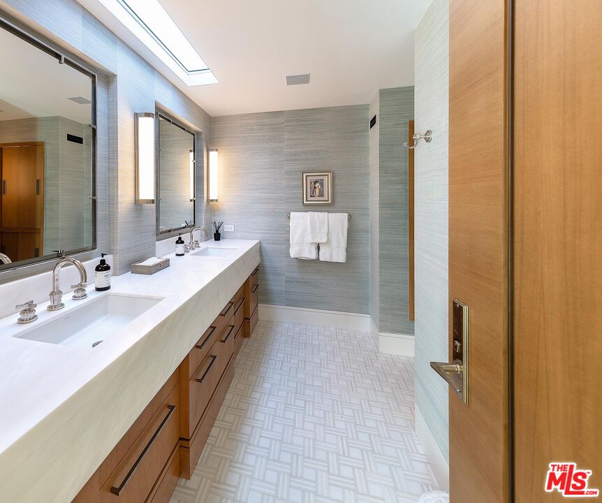 984 North Alpine Drive Beverly Hills, CA 90210 - Photo 23 of 25 a spacious bathroom with a double vanity sink a mirror and a shower