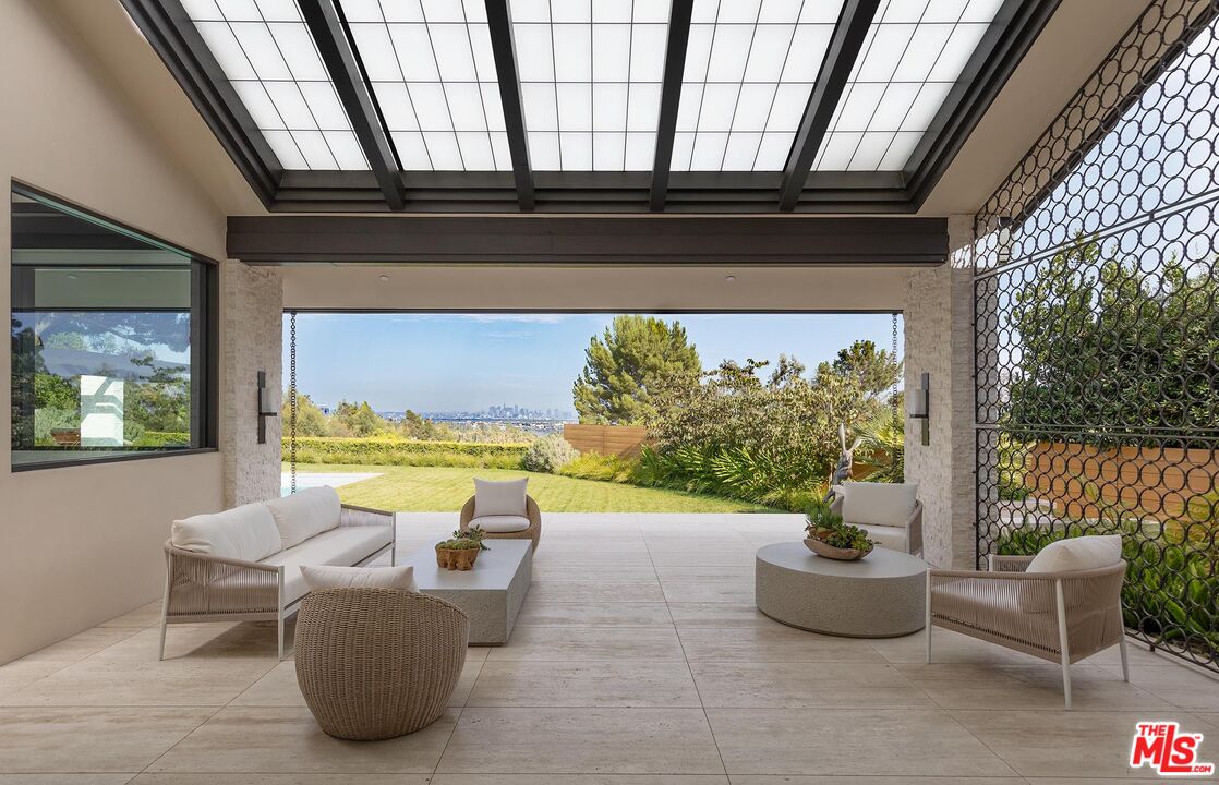 984 North Alpine Drive Beverly Hills, CA 90210 - Photo 24 of 25 a view of swimming pool with outdoor seating and plants