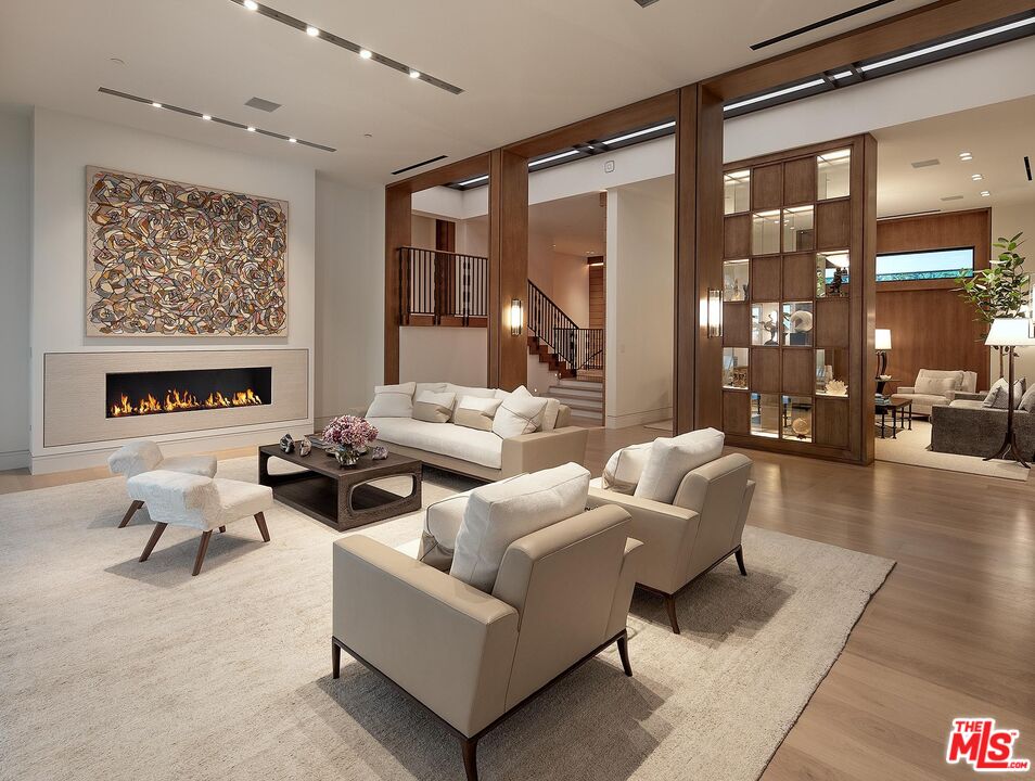 984 North Alpine Drive Beverly Hills, CA 90210 - Photo 4 of 25 a living room with furniture and a fireplace