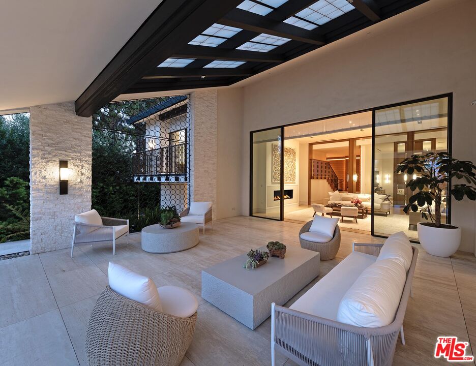 984 North Alpine Drive Beverly Hills, CA 90210 - Photo 7 of 25 a living room with furniture and potted plants