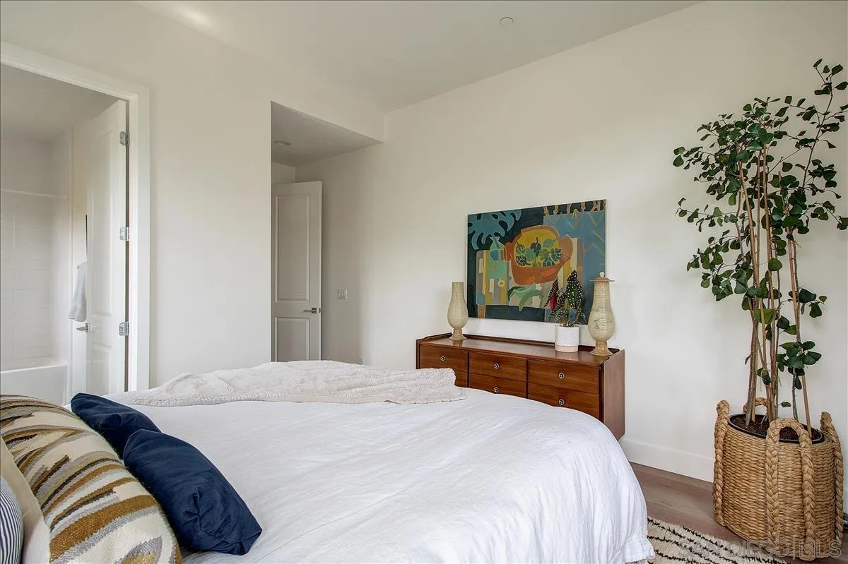 656 Jocelyn Way Encinitas, CA 92024 - Photo 13 of 35 a bedroom with a bed and a potted plant