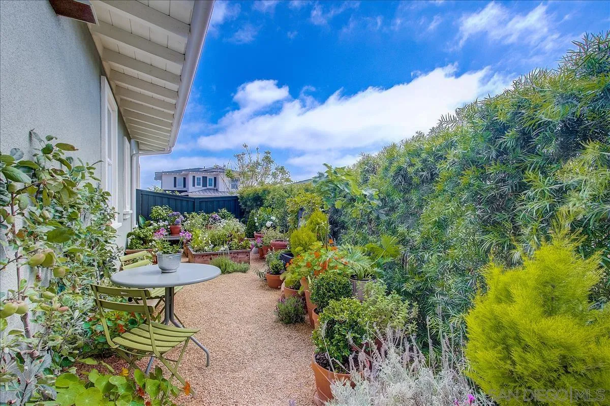 656 Jocelyn Way Encinitas, CA 92024 - Photo 27 of 35 a view of a table and chairs in a backyard of a house