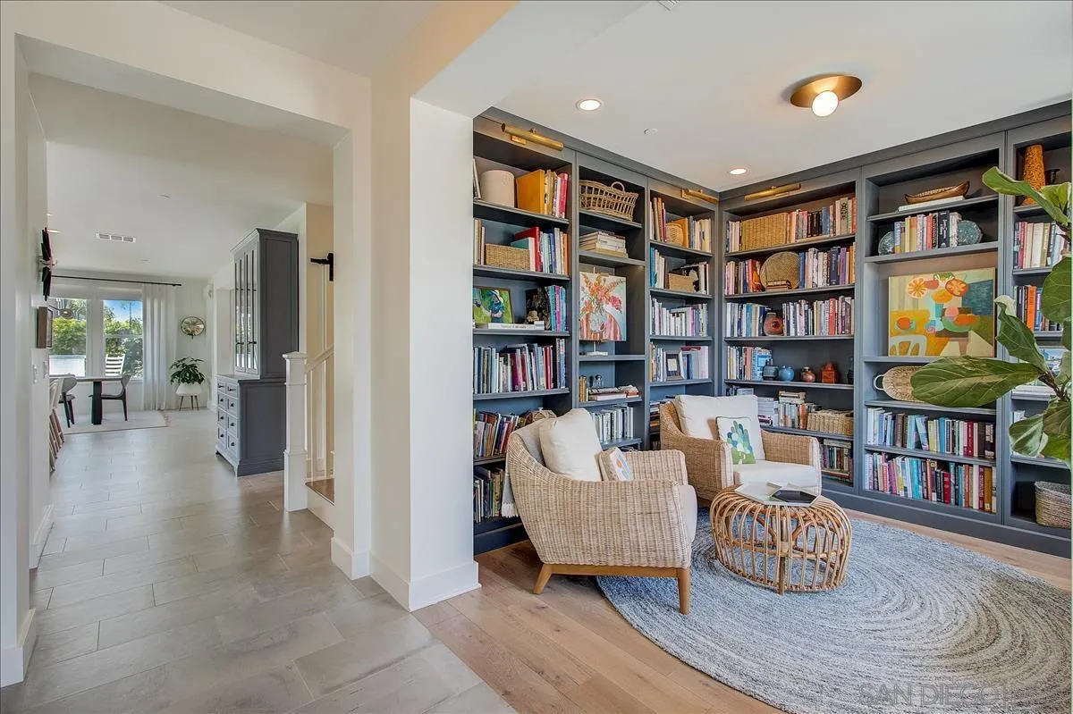 656 Jocelyn Way Encinitas, CA 92024 - Photo 7 of 35 a living room with fireplace furniture and a book shelf