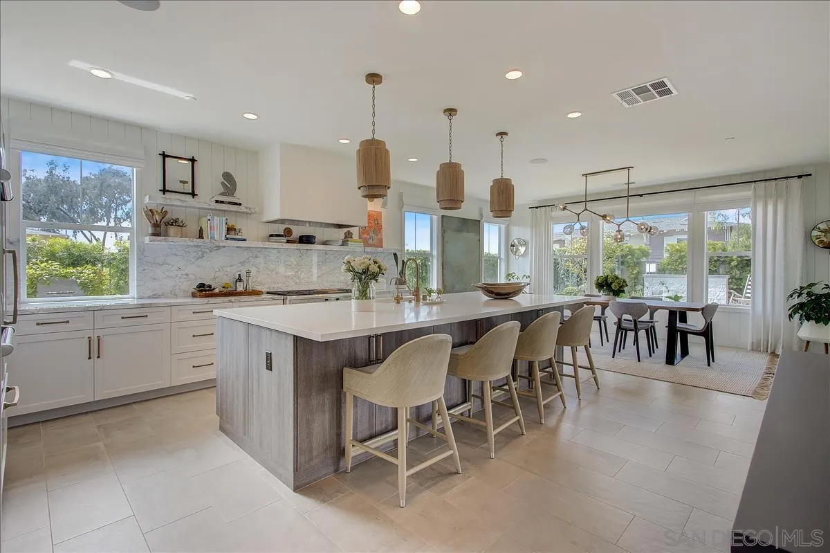656 Jocelyn Way Encinitas, CA 92024 - Photo 8 of 35 a kitchen with lots of counter space dining table and chairs