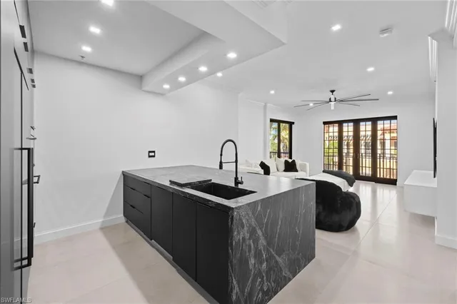 a kitchen with stainless steel appliances granite countertop a sink a stove and a granite counter tops