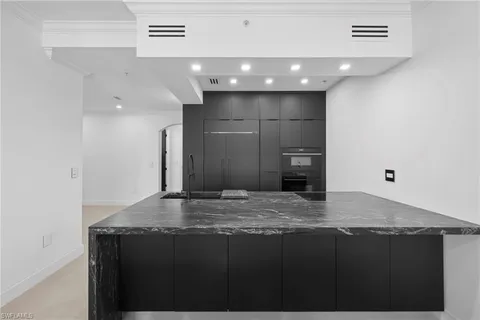 a view of kitchen with a sink refrigerator and wooden floor