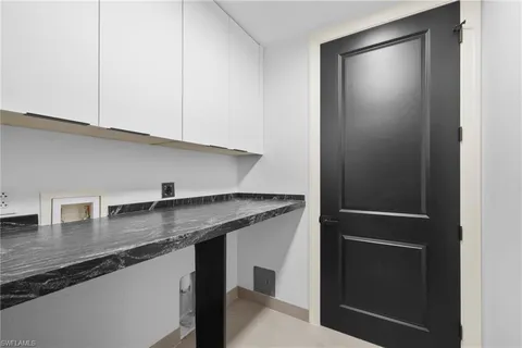 a kitchen with stainless steel appliances granite countertop a sink and a refrigerator