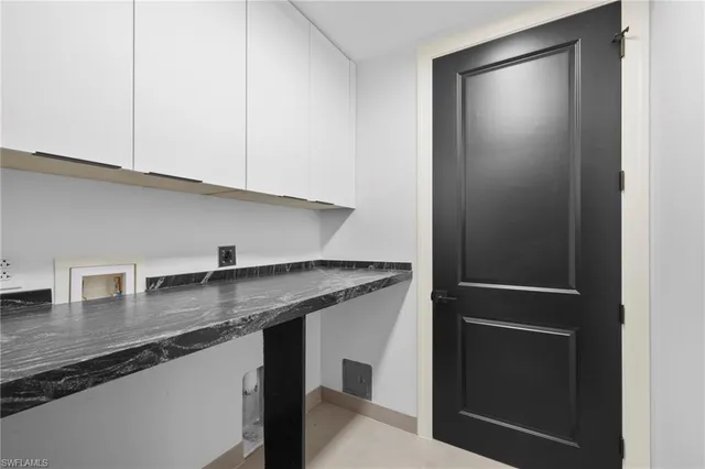 a kitchen with stainless steel appliances granite countertop a sink and a refrigerator