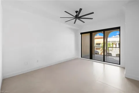 a view of a livingroom with a ceiling fan and window