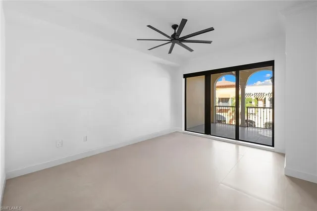 a view of a livingroom with a ceiling fan and window