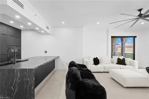 a large bedroom with a bed a couch and a large window