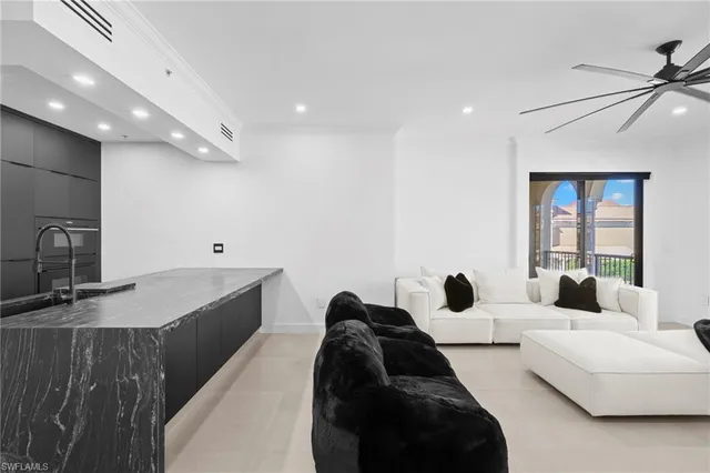 a large bedroom with a bed a couch and a large window