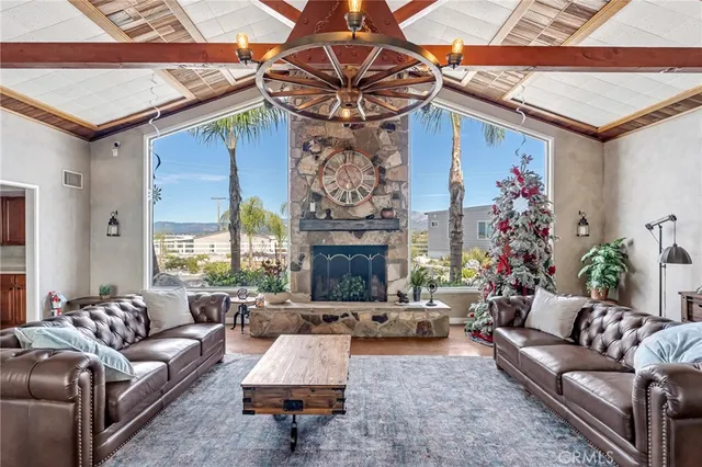 a living room with furniture a fireplace and a chandelier