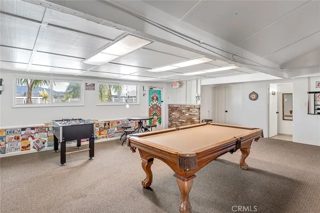 a room with furniture and pool table