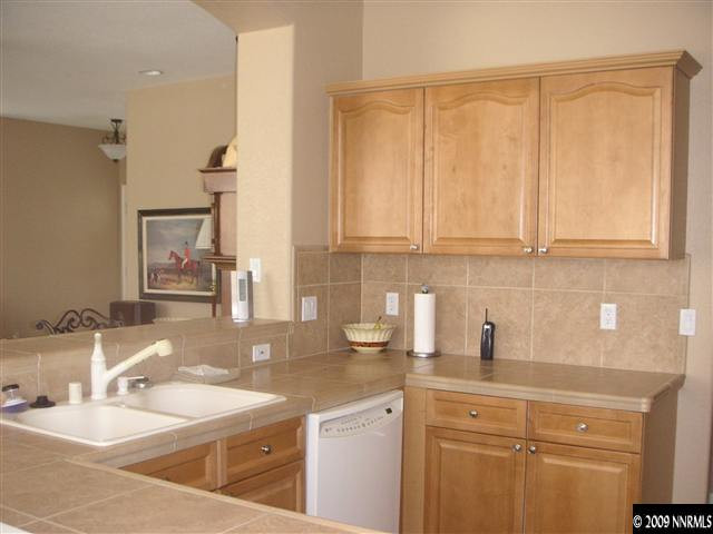1730 River Gorge Court Reno, NV 89521 - Photo 2 of 9 a kitchen with stainless steel appliances granite countertop a sink and a white cabinets