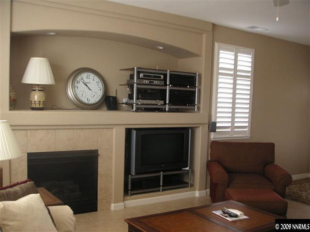 1730 River Gorge Court Reno, NV 89521 - Photo 5 of 9 a living room with furniture a window and a fireplace