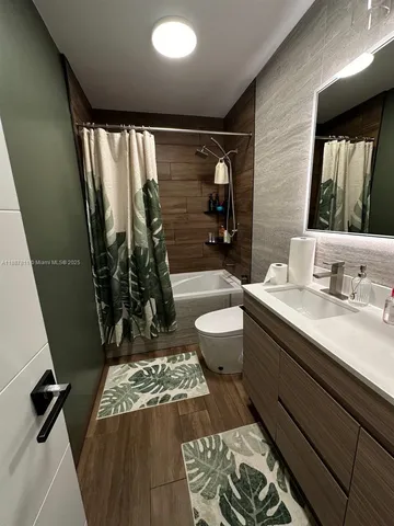 a bathroom with a double vanity sink toilet and shower